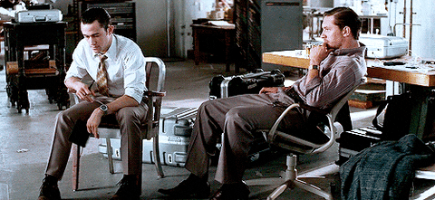 Arthur looking at Eames, who smiles back
