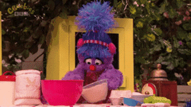 Muppets from Sesame Street cooking and making a mess.