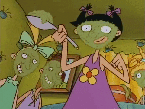 [Gif description: three girls with green face masks on with one holding a spoon full of the green mask] via Giphy