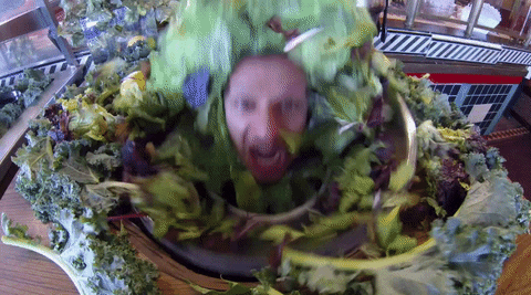 Man's head popping out of a vegan salad bowl