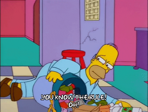 Homer Simpson lying next to a bucket of trash. Homer Simpson lying next to a bucket of trash.