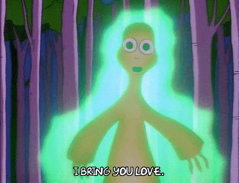 an alien saying "I bring you love" in front of trees