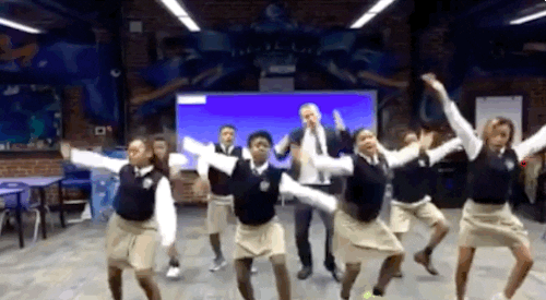 Gif of a teacher dancing with his students.