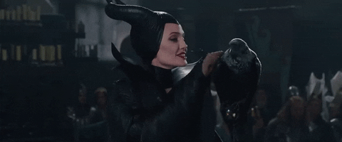 Maleficent (Angelina Jolie) stroking Diaval in raven form