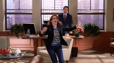 Liz Lemon from 30 Rock running with joy and arms raised up