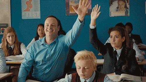 Man Trying to overshadow peer raising hands in class