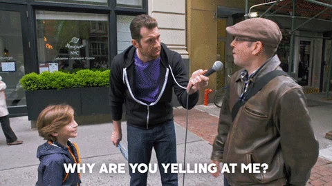 A man being interviewed on the street asking why are you yelling at me