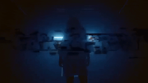 An animated gif of a person standing in the darkness and then the words "carry on" appear in big block letters.