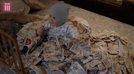 toddler swimming in money gif