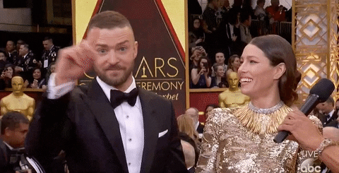 Justin Timberlake and Jessica Biel joking during an interview on the Oscars red carpet.