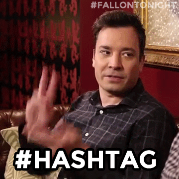 GIF of Jimmy Fallon clapping his fingers together in a way that makes them look like a hashtag