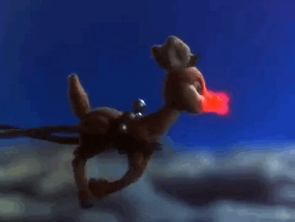 Gif by Warner Brothers Archive of Rudolph the Red-Nosed Reindeer pulling the sleigh through the air. 
