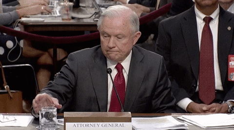 US Attorney General Jeff Sessions takes a sip of water.