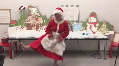 Woman dressed as Santa Clause dancing funnily