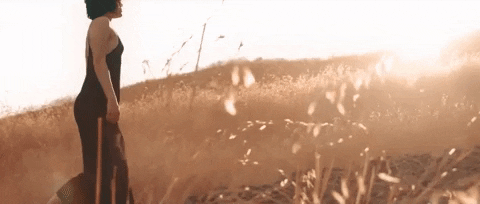 femme marchant au soleil en sentant un doux parfum de bonheur