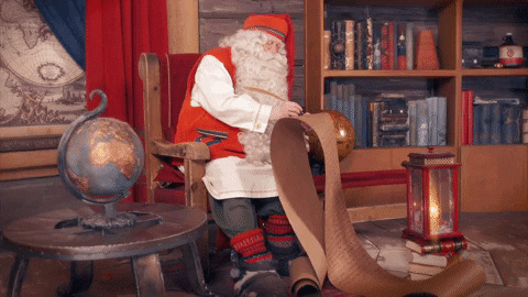 Santa making a long list and checking it twice, then waving 