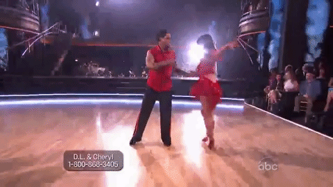 D. L and Cheryl dancing in red outfits. D. L and Cheryl dancing in red outfits.