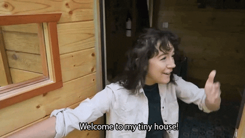 gif of a woman making a virtual visit of her house, saying "welcome to my tiny house!"
