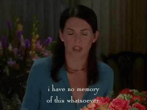 Ein GIF aus der Serie "Gilmore Girls". Zu sehen ist Lorelai Gilmore in einer Szene, die beim wöchentlichen Abendessen bei ihren Eltern spielt. Der Untertitel lautet: "I have no memory of this whatsoever." Sie trägt eine blaue Bluse und im Hintergrund sind verschiedene Blumensträuße zu sehen.