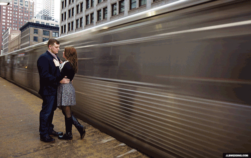 Couple alongside moving train