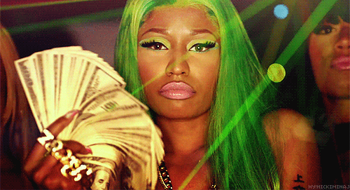 Nicki Minaj wearing a green wig fans around her face her money
