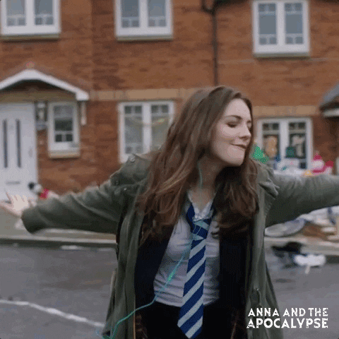 Anna dancing down a street