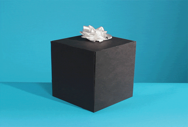 A plain black gift box with a white bow on top completely opens to expose a hand flipping the bird.