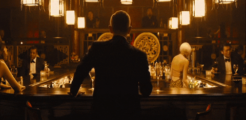 James Bond enjoys a drink at a bar
