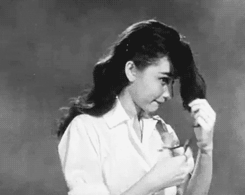 Audrey Hepburn cutting her own bangs - black and white gif 