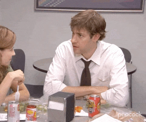 The Office: Jim Halpert, seated at a lunch table, turns his head and says "Wait. What?!"