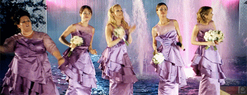 [Image description: Wedding scene from Bridesmaids where "Hold On" is playing and everyone is dancing Image via Giphy]